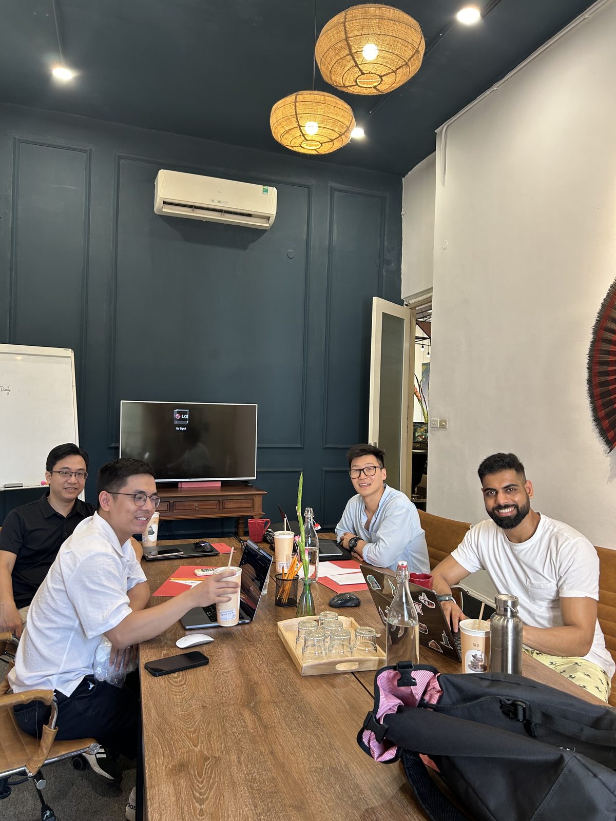 Pivot Labs team around a work table with laptops and drinks